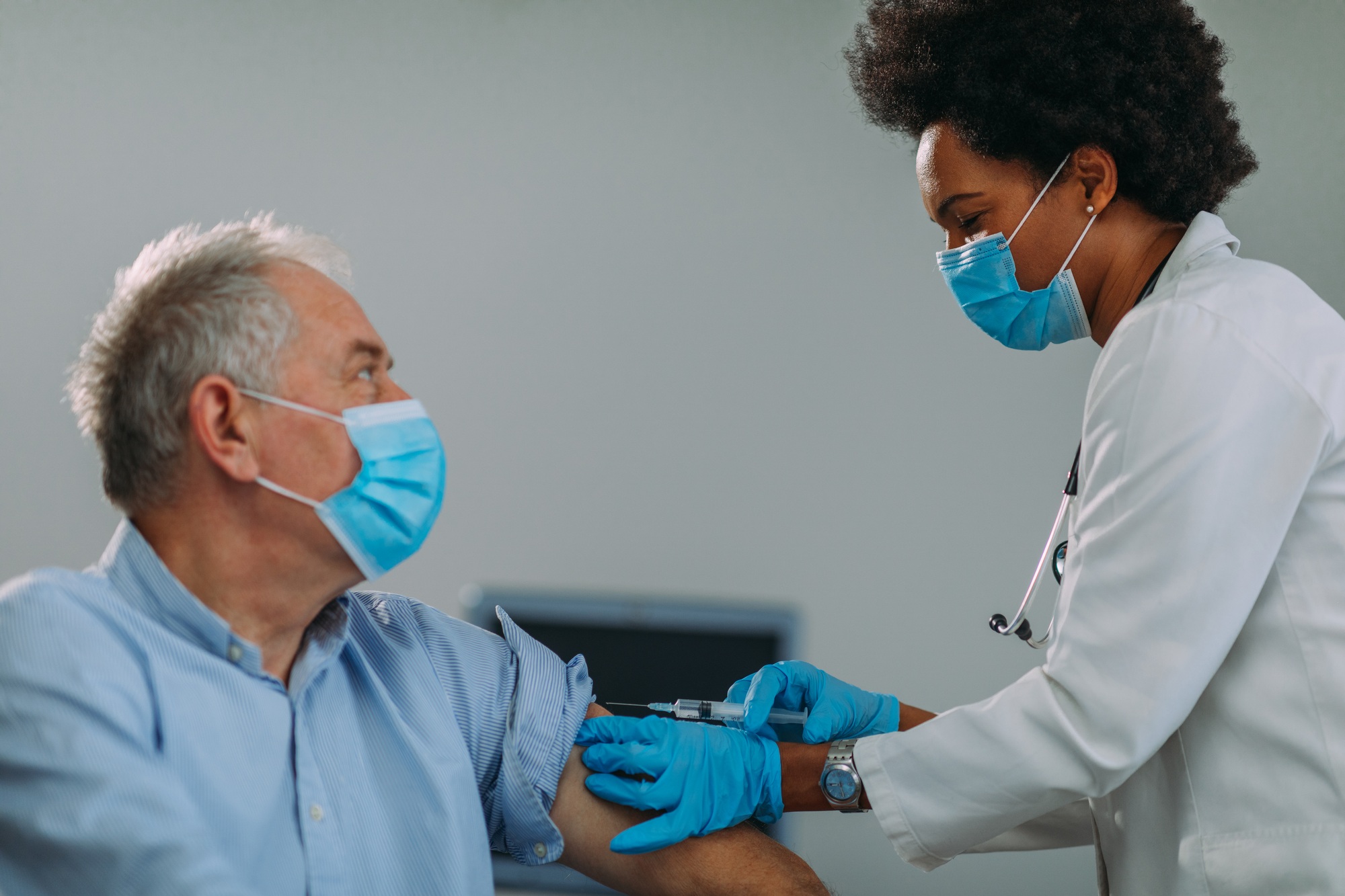 Senior man getting vaccinated at hospital